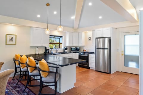 Fully Stocked Gourmet Kitchen with Bar Seating.