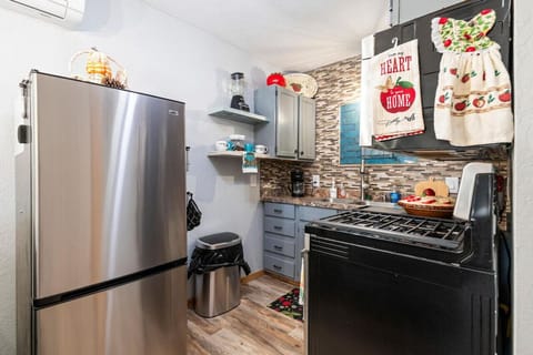 Full kitchen with refrigerator, stove and microwave.