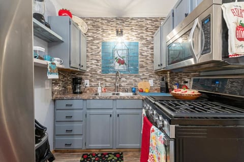 Full size kitchens ink with stove, microwave and refrigerator.