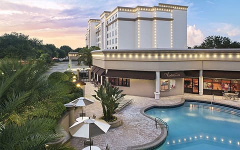 Sip and relax by the pool with evening ambiance.