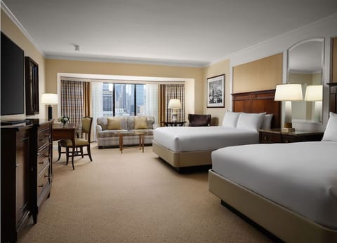Wake up to skyline views from a serene double-queen room.