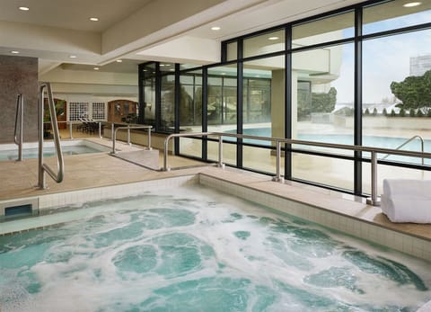 Unwind in bubbling hot tub serenity beside panoramic windows.