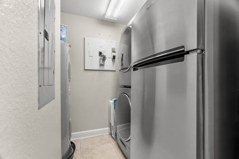 Laundry Room off of Kitchen with New Washer and Dryer and an Additional Stainless-Steel Refrigerator