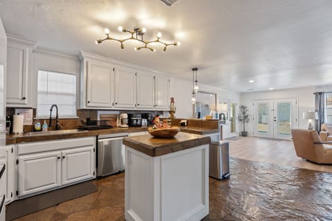 Full kitchen  white cabinets with butcher block counters and updated appliances.