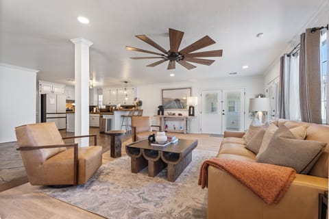 Full seating arrangement and open-concept layout with natural light from windows.