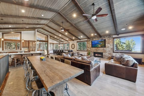 Relax in your spacious open-concept living space with vaulted ceilings, cozy fireplace, and mountain views through expansive windows.