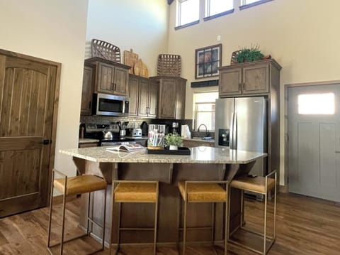 Enjoy cooking your favorite meal for family and friends in our fully stocked kitchen with seating for four around the island. Our granite countertops and stainless steel appliances add a sense of luxury to your stay!