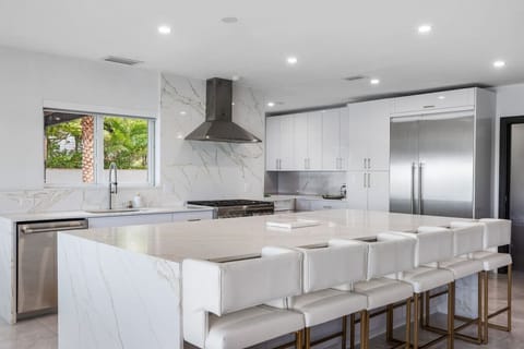 Contemporary culinary space with premium fixtures and stylish breakfast counter arrangement