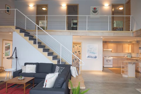 Living area showing vaulted ceiling with bedrooms upstairs