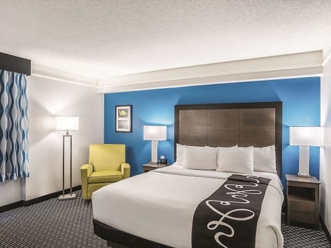 Unwind in a crisp king bed with soothing blue accents.