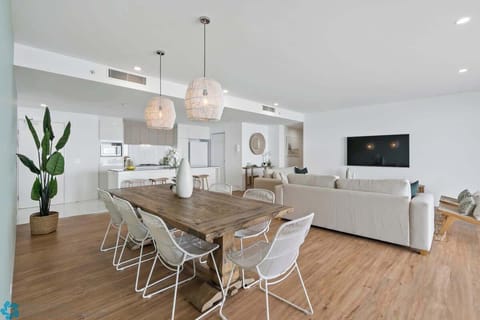 Solid wood dining table in an open plan area with seating for 8. 