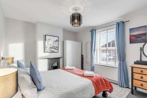Bright bedroom with a cozy bed and charming decor.