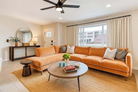 Bright open floor living space featuring a smart flat-screen TV, and designer furnishings.