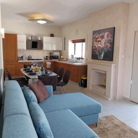 Living area onlooking dining area and the kitchen.