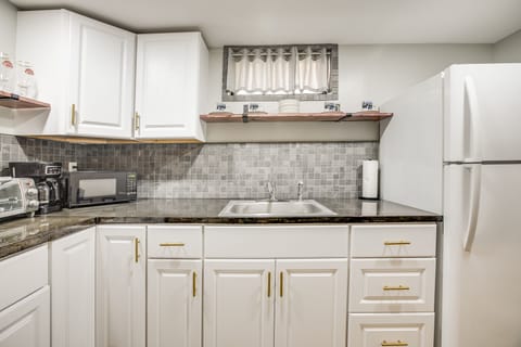 There's a second kitchen in the basement, with full-size fridge and sink, 2-burner stove, coffeemaker, microwave, and toaster oven.