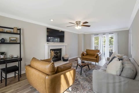 Modern living space in gray and white with cozy brown touches