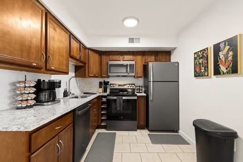 Warm wooden cabinets and modern finishes give this kitchen a welcoming, homey vibe.
