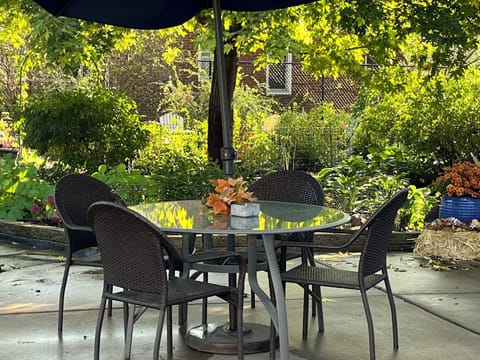 Private rear patio includes dining area, lounge furniture and gas grill.  