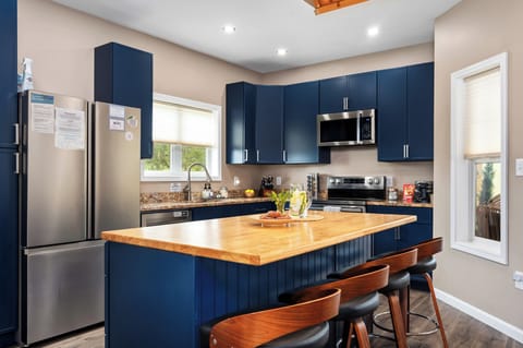 A huge island to prepare meals or sit around while you sip drinks. You’ll also find a double Belgian waffle maker on the counter behind it for a fun morning treat!