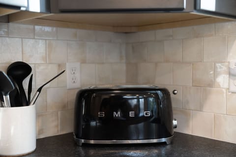 Enjoy cooking in a high-end kitchen featuring a sleek SMEG toaster