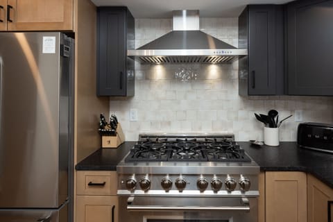 Cook like a pro with a six-burner gas range and luxury hood, perfect for prepping gourmet meals