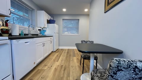 Enjoy a spotless kitchen just steps away from the dining table, perfect for meals and gatherings!