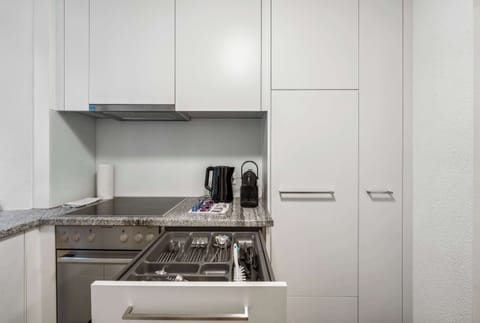 Countertop area with microwave and Nespresso coffee machine.