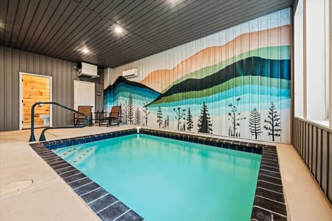 Enjoy your very own heated indoor pool surrounded by vibrant mountain mural art—fun for the whole family, rain or shine.