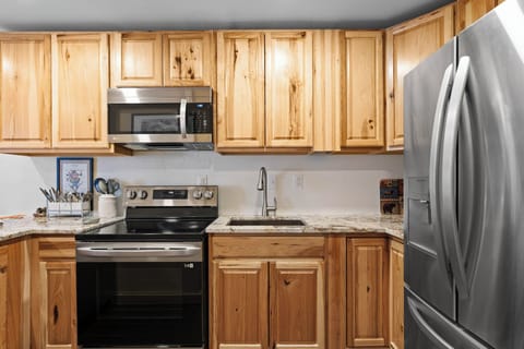 Full kitchen with stainless steel appliances.