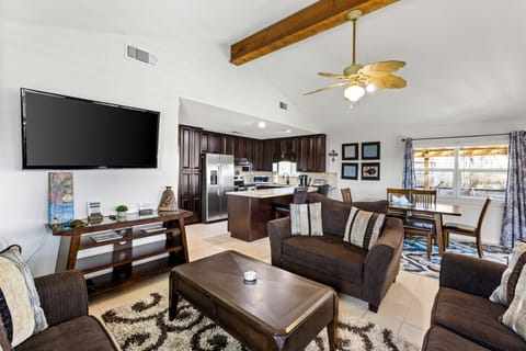 Open living room with ample seating and a TV.