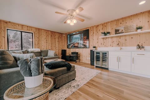 Room to spread out in the bonus family room. Comfy sectional, 100” TV, wet bar!