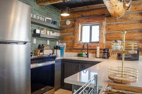 Kitchen has full size refrigerator, freezer, oven, 4 burner stove, and microwave