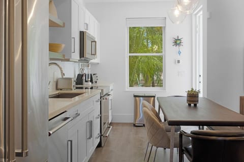Beautiful kitchen and dining area leading to the back door entrance to the pool.