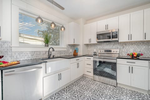 Fully equipped kitchen featuring sleek stainless steel appliances and generous counter space for all your cooking needs.