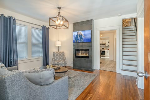 Unwind in the chic living room, featuring plush seating, a fireplace, and a Smart TV for your entertainment.