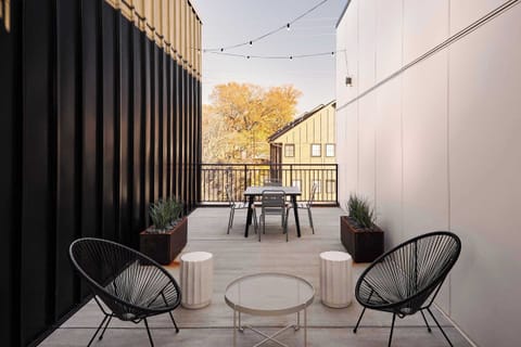 Modern patio with cozy seating and a dining area, just outside your area!