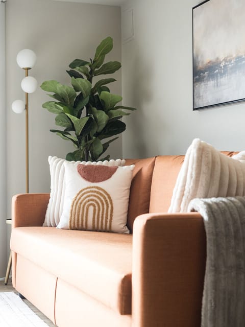 Imagine yourself sinking into the plush couch, surrounded by soft pillows and a cozy blanket. This living room invites you to curl up, relax, and truly make yourself at home.