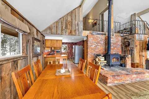 Rustic home with a cozy dining area, open-concept kitchen, and vaulted ceiling.
