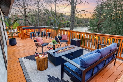 Unwind on the spacious upper deck with a firepit and lakefront scenery.