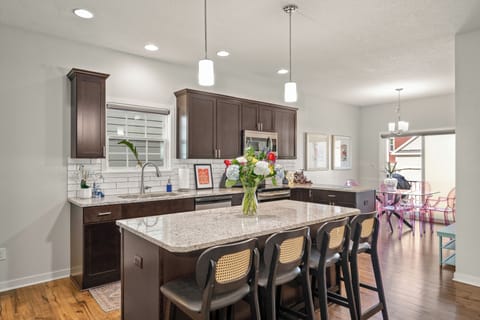 The kitchen island is perfect for a buffet, with lots of seating for all!