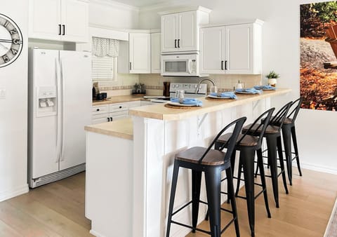 The fully equipped kitchen has island seating - perfect for group breakfasts!