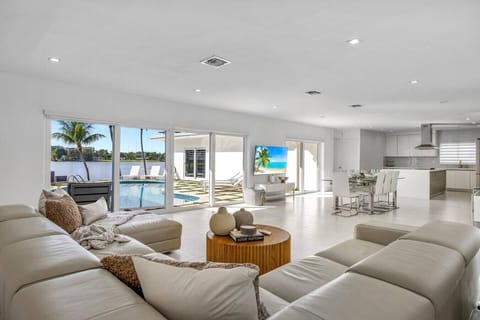 Modern great room with stunning waterfront vistas and elegant sectional seating arrangement