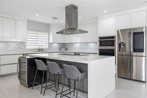 Modern culinary space with premium appliances and elegant breakfast bar arrangement