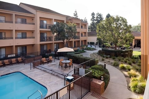 Dive into sunshine by the sparkling pool and courtyard seating.