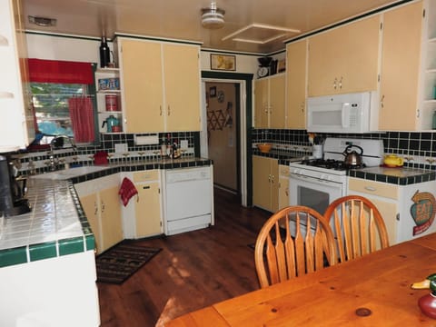 The refrigerator & washer/dryer are through that doorway & leads to a back deck.