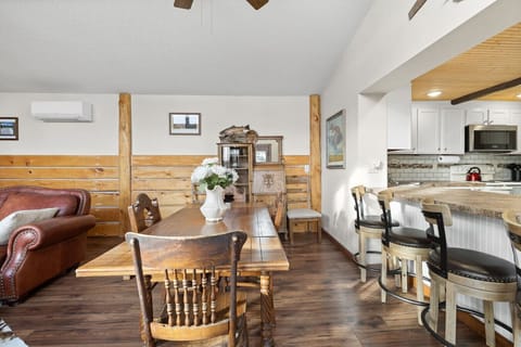 The dining area offers a spacious and inviting setting, ideal for enjoying meals together while taking in the surrounding views and natural light.