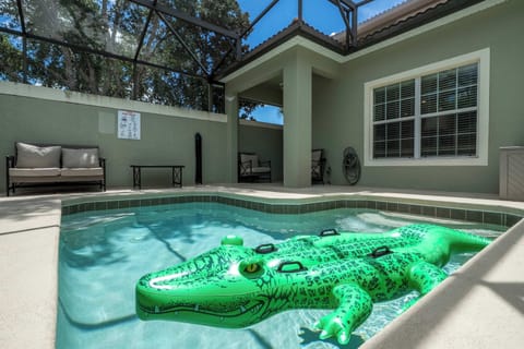 Enjoy your own private screened-in pool oasis-perfect for sunny relaxation and playful swims with a fun inflatable gator! Ample patio seating invites you to lounge in comfort outdoors.