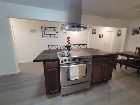 Center Island with fully equipped kitchen with air fryer microwave, coffee maker,  waffle maker and basic condiments.