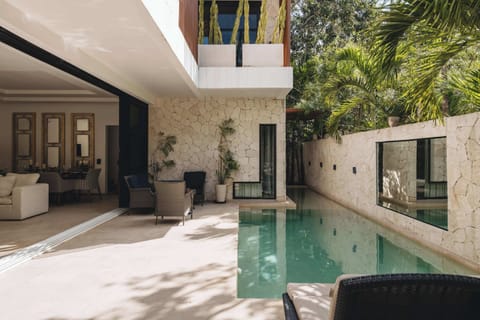 Impressive patio with a pool. Large windows open up, allowing the interior space to connect with the exterior.