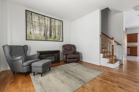 Cozy living room with a wood-burning stove insert and views up to the second floor.